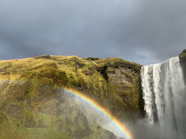 travel more and visit this beautiful waterfall and rainbow in southern iceland