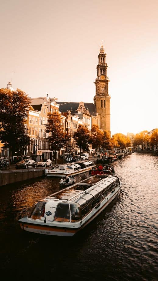 A serene canal cruise during a golden sunset in Amsterdam