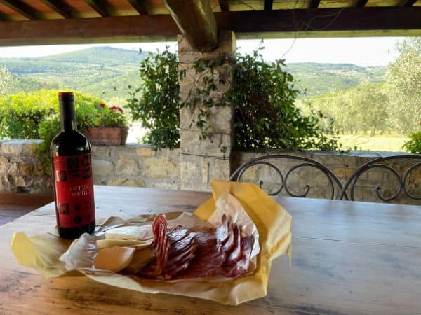 wine and charcuterie at a picnic table in Tuscany