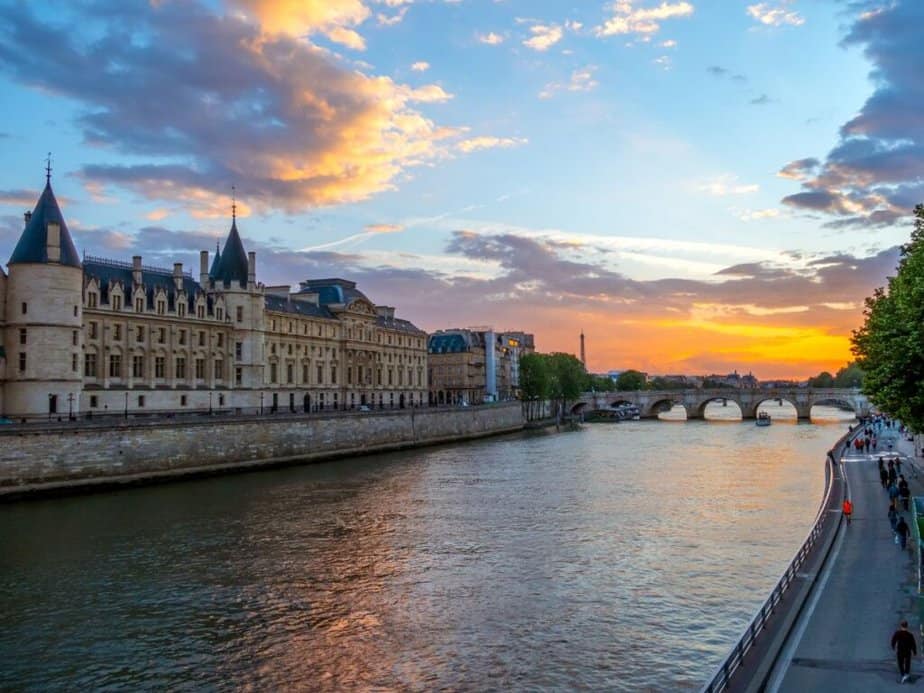 Sunset over the Seine River in Paris  and the silhouette of the Eiffel Tower against the fiery sky, a picturesque scene for any Paris bucket list